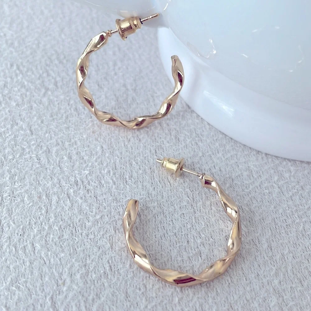 Medium twisted hoop gold earrings